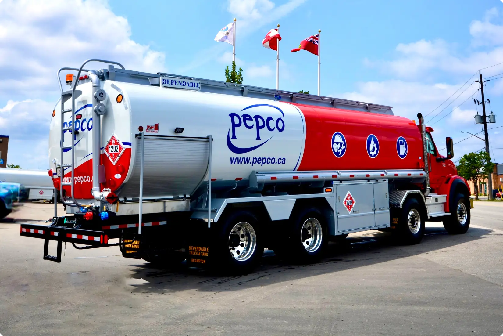 wrapped fuel truck with flags parked on the road