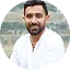 a man in white dress