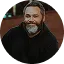 a smiling man in black dress